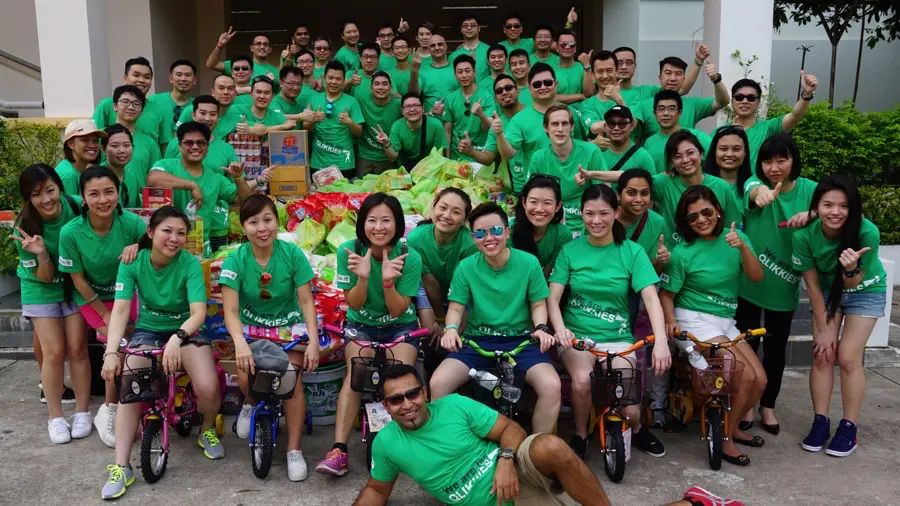 Corporate group celebrating a charity donation event in Bangkok