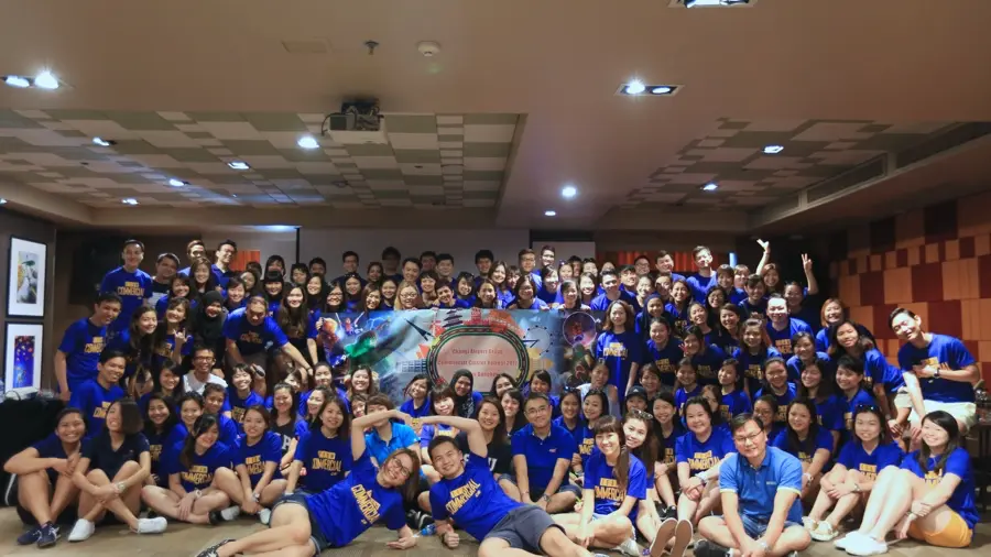 Corporate team day group in matching shirts celebrating in Bangkok
