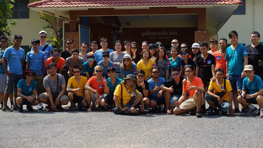 Corporate group visiting an orphanage during a CSR charity event in Thailand