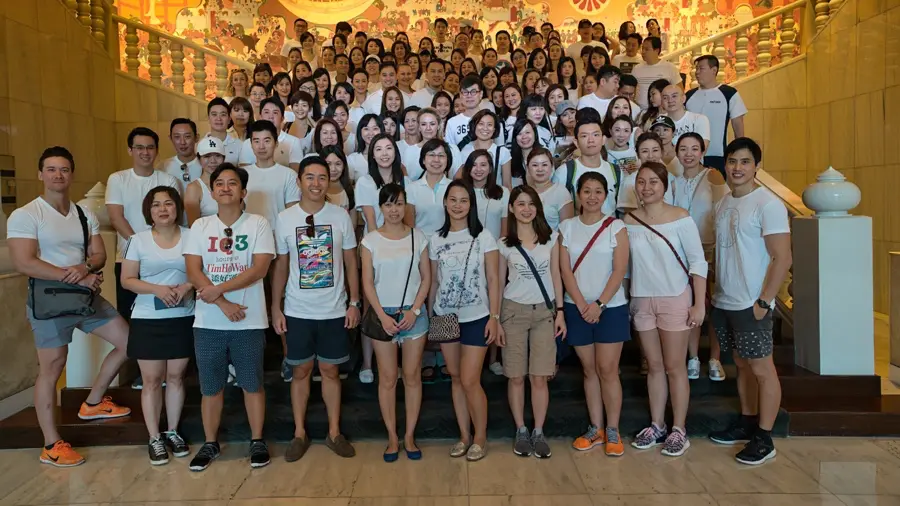 Staff day out group photo on a hotel staircase in Bangkok