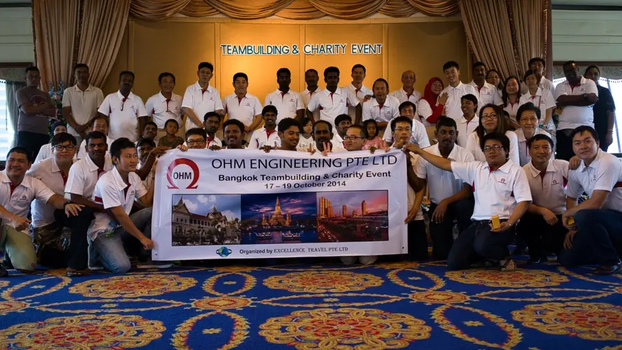 Team building in Bangkok group celebration with a charity event banner