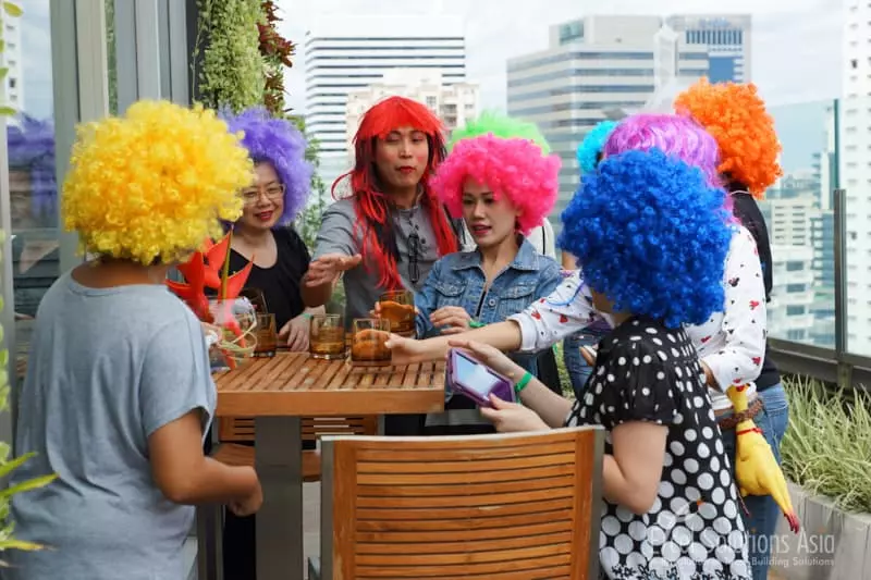 Actors wearing prop wigs in a fun corporate event