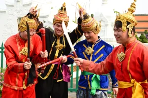 Team members dressed in traditional Thai costume during an event in Bangkok