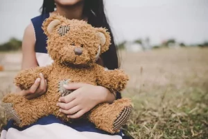 Build a Bear girl holding teddy