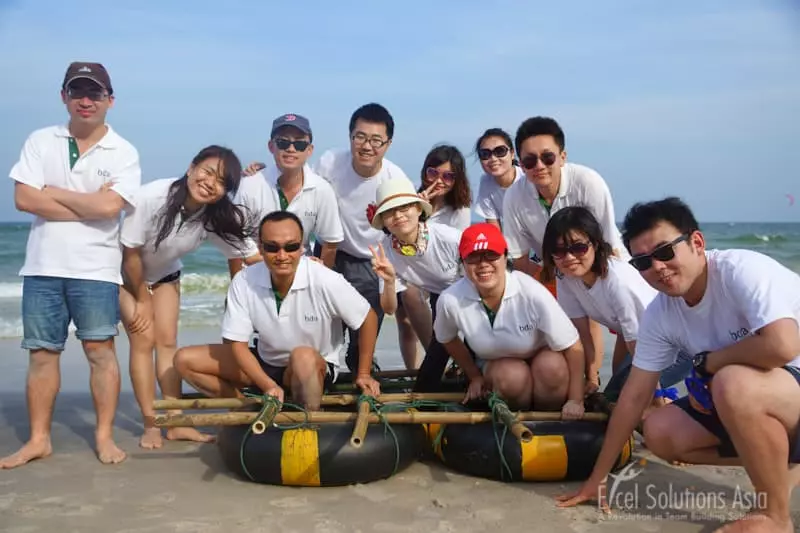 Corporate teams sit on their rafts made of bamboo and floats on a beach in Hua Hin