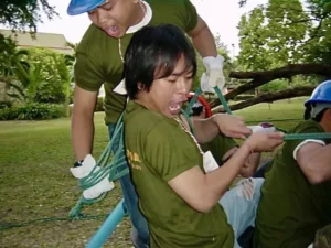 Two team members enthusiastically shouting during a team building activity in Bangkok, demonstrating strong communication.
