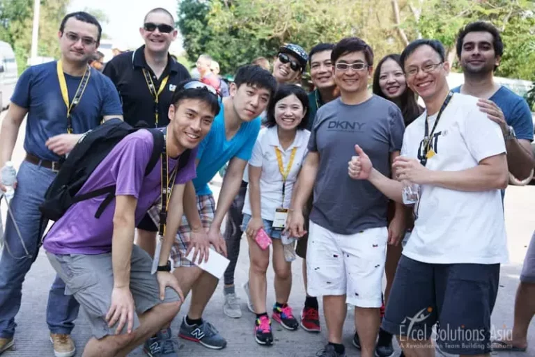 Happy team members posing together during a Scavenger Hunt in Hua Hin, Thailand.