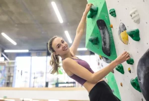 Lady participates indoor rock climbing