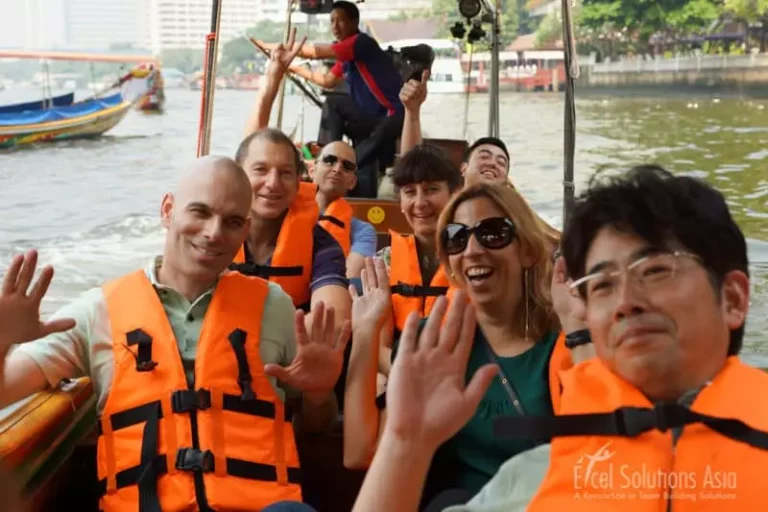 Teams wearing life jackets on a Bangkok Long Tail Boat