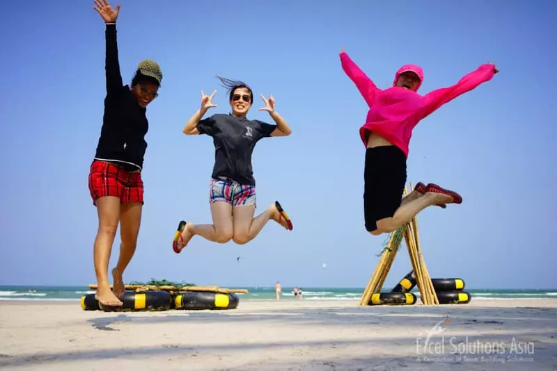 Winning team members celebrate on a beach in Hua Hin