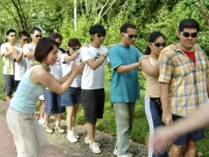 Blindfolded team members participating in traditional team building games in Bangkok, enhancing trust, and communication.